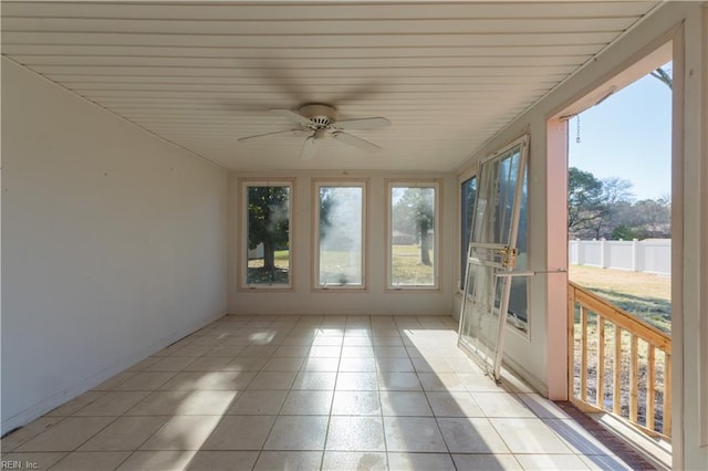 unfurnished sunroom with ceiling fan