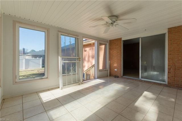 unfurnished sunroom with wooden ceiling and ceiling fan