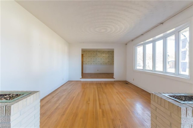 unfurnished living room with light hardwood / wood-style flooring