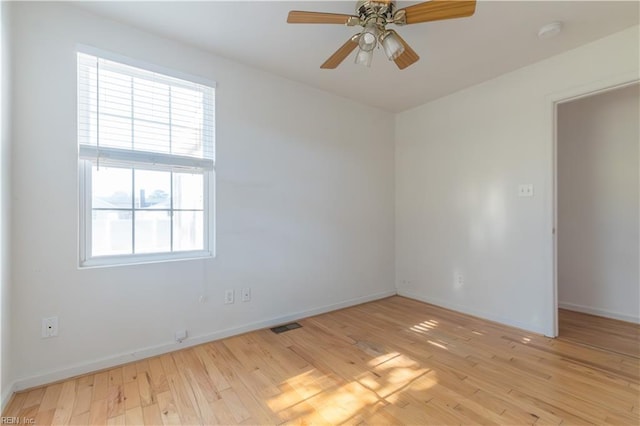 empty room featuring ceiling fan and light hardwood / wood-style floors