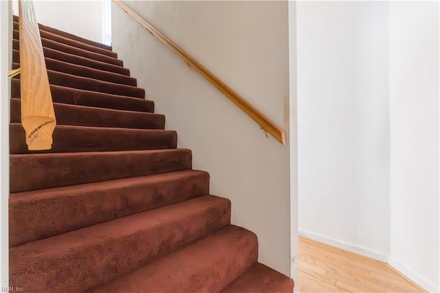 stairs with hardwood / wood-style floors