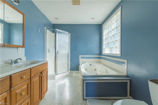 bathroom featuring vanity and shower with separate bathtub