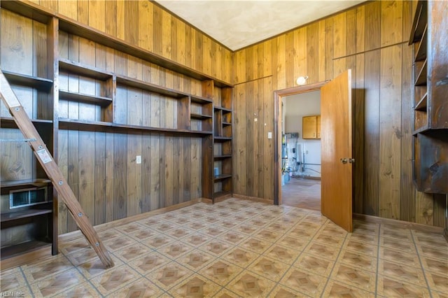 unfurnished living room with wood walls