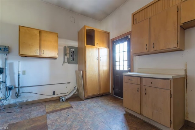 kitchen with light brown cabinets and electric panel