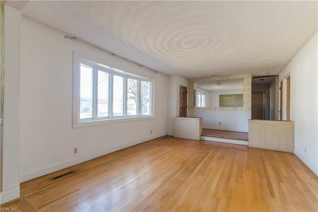 unfurnished living room featuring light hardwood / wood-style flooring