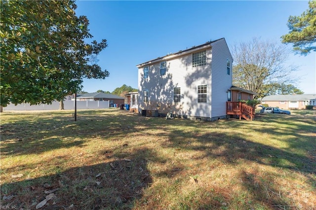 rear view of property featuring a yard