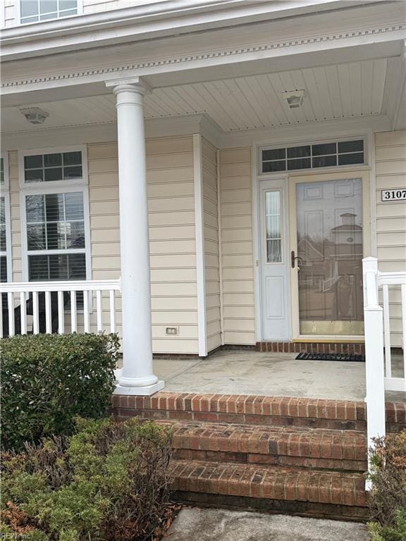 view of exterior entry featuring a porch