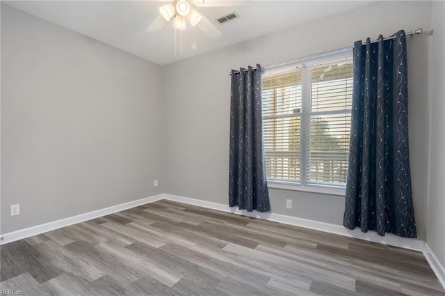 spare room featuring ceiling fan and light hardwood / wood-style floors