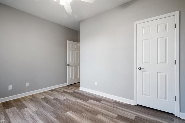 spare room featuring ceiling fan and light hardwood / wood-style flooring