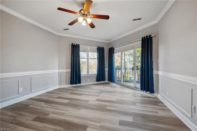 empty room featuring ornamental molding, ceiling fan, and light hardwood / wood-style floors