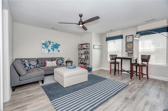 living room with ceiling fan and hardwood / wood-style floors