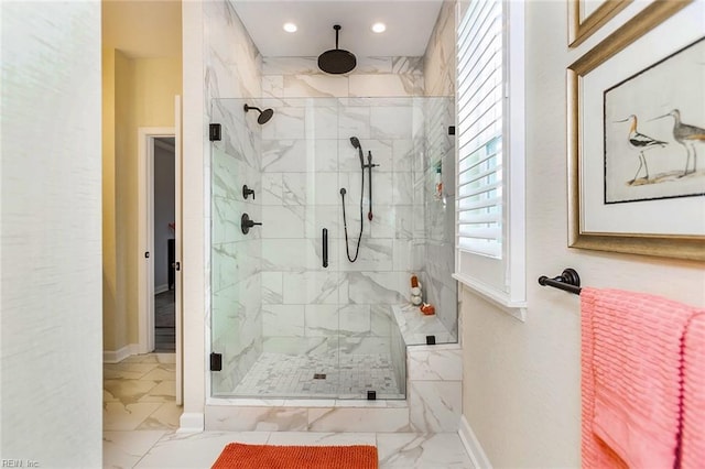 bathroom with a shower with door