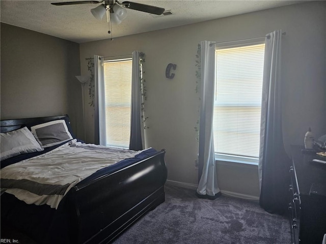 carpeted bedroom with ceiling fan and a textured ceiling