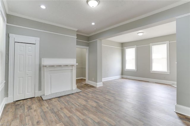 unfurnished living room featuring crown molding and wood-type flooring