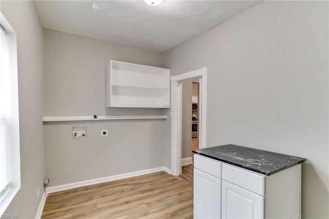 laundry area featuring hookup for a washing machine, electric dryer hookup, cabinets, and light hardwood / wood-style flooring