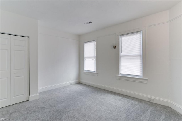 unfurnished room featuring light colored carpet