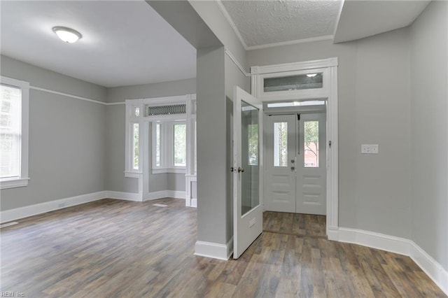 entryway featuring dark wood-type flooring, a textured ceiling, and french doors