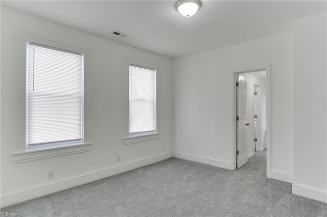 unfurnished room featuring light colored carpet