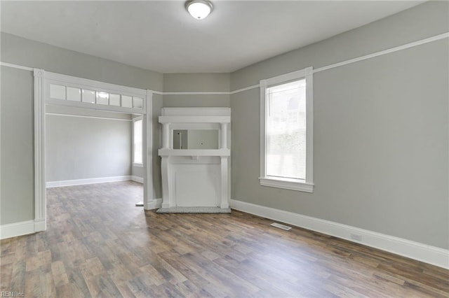 unfurnished living room featuring hardwood / wood-style floors