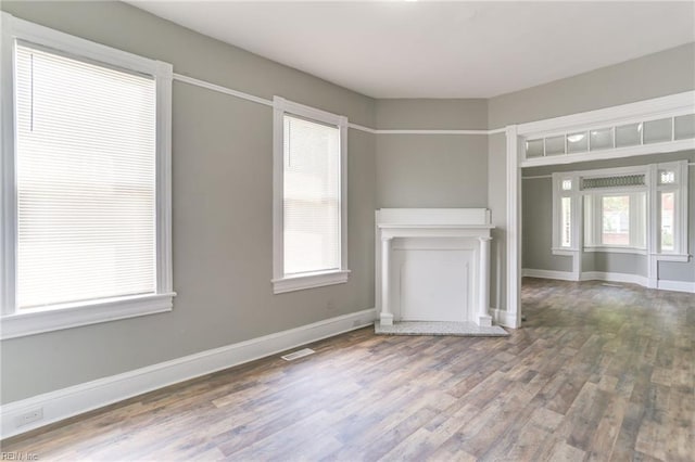 unfurnished living room with hardwood / wood-style flooring