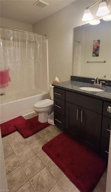 full bathroom featuring vanity, tile patterned floors, toilet, and shower / bath combo