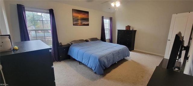 bedroom featuring light colored carpet and ceiling fan