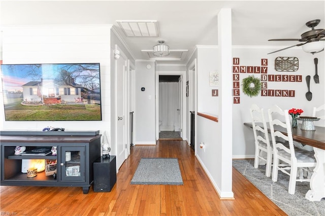 corridor with crown molding and hardwood / wood-style flooring