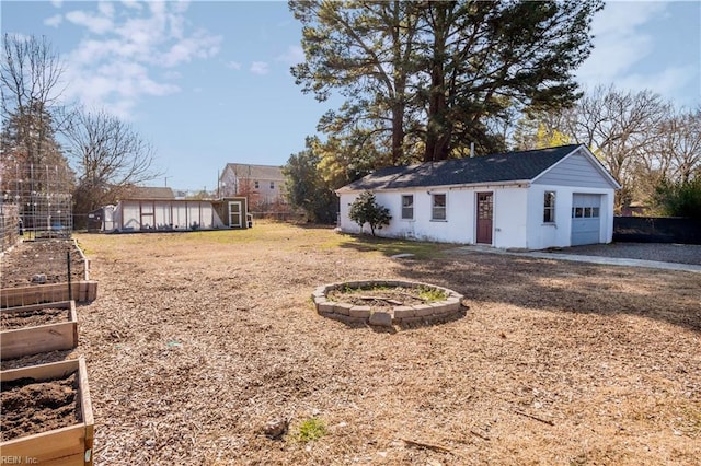 view of yard featuring a garage and a storage unit