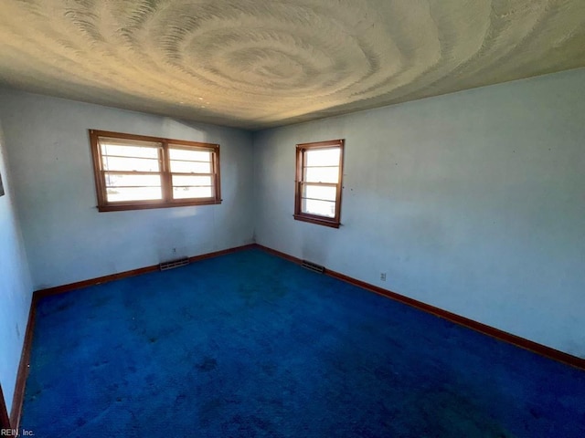 empty room with dark colored carpet