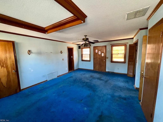 unfurnished living room with dark carpet, ceiling fan, crown molding, and a textured ceiling