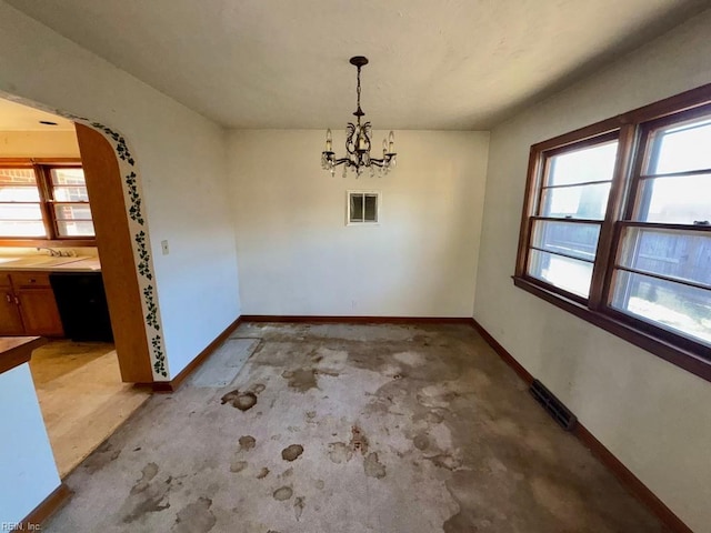 unfurnished dining area with an inviting chandelier and sink