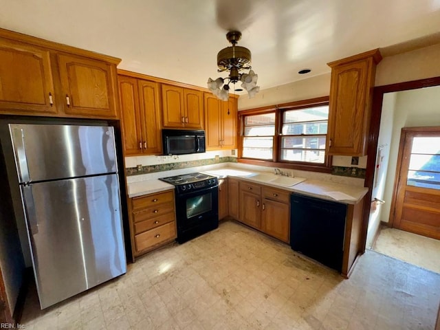 kitchen with plenty of natural light, sink, and black appliances