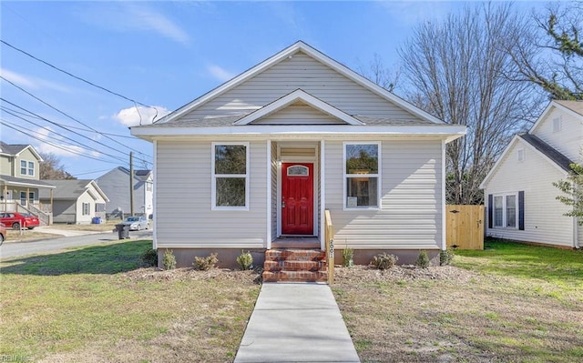 bungalow-style house with a front yard