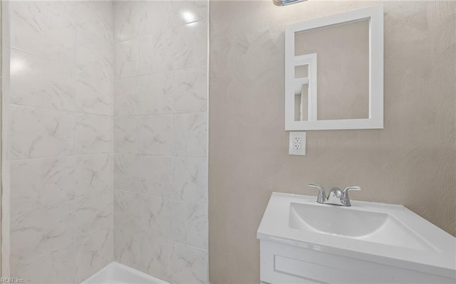 bathroom featuring vanity and a tile shower