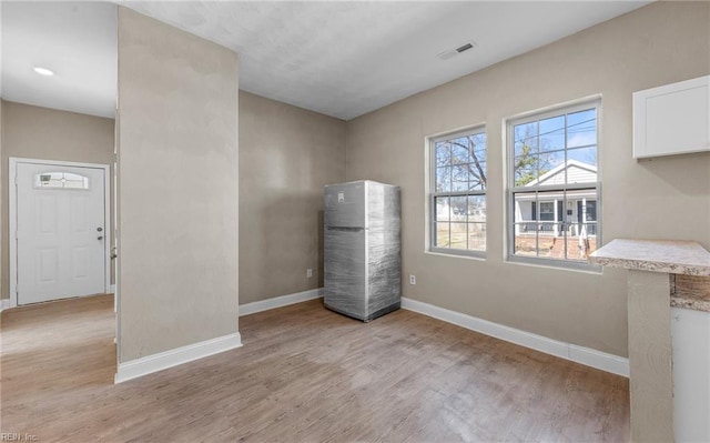 unfurnished room featuring light wood-type flooring