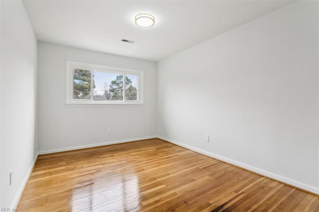 spare room featuring light hardwood / wood-style flooring