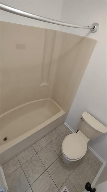 bathroom featuring toilet and tile patterned flooring