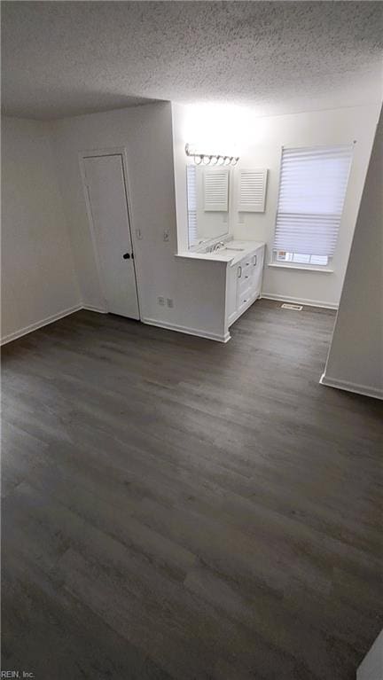 interior space featuring wood-type flooring and a textured ceiling