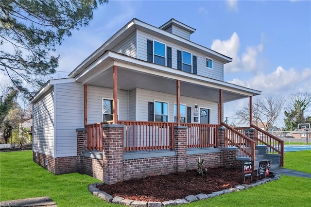 view of front of house with a porch and a front lawn