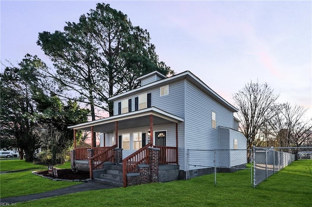 view of front facade with a yard and covered porch