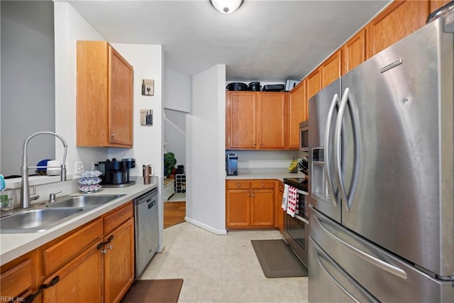 kitchen with sink and appliances with stainless steel finishes