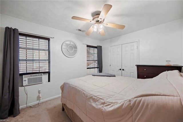 bedroom with a closet, light carpet, ceiling fan, and cooling unit