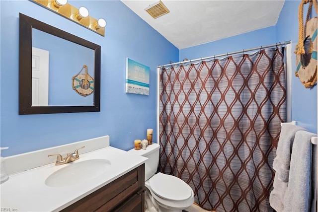 bathroom featuring vanity, a shower with curtain, and toilet