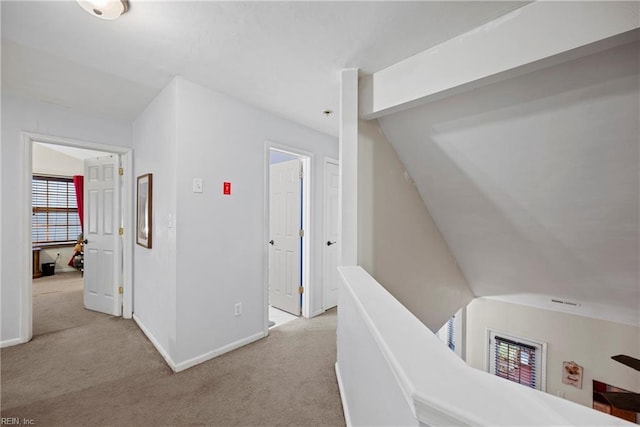 corridor featuring light colored carpet