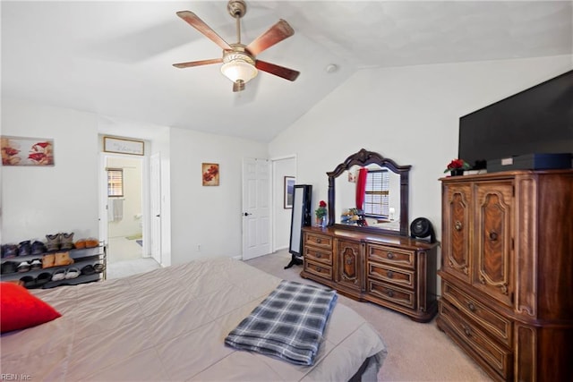 carpeted bedroom with vaulted ceiling, ensuite bathroom, and ceiling fan