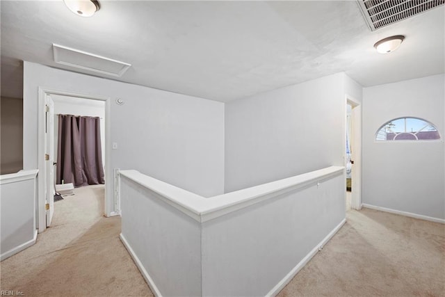 hallway featuring light colored carpet