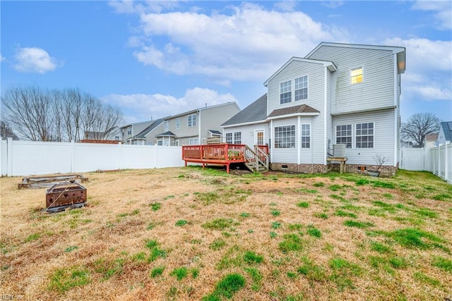 back of property featuring a wooden deck, an outdoor fire pit, and a yard