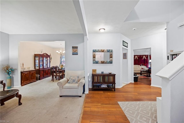 living room featuring a notable chandelier and light hardwood / wood-style flooring