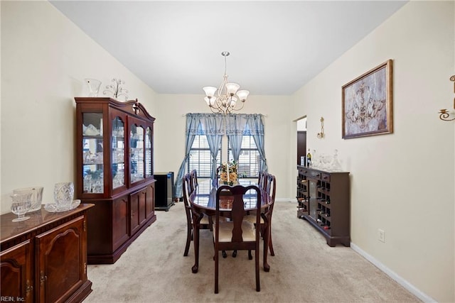 carpeted dining space with an inviting chandelier