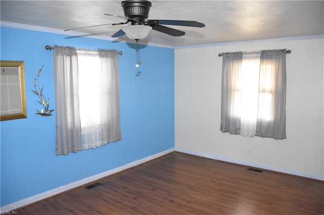 unfurnished room with dark hardwood / wood-style flooring, ceiling fan, ornamental molding, and a healthy amount of sunlight